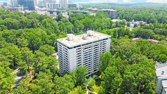 a view of a city with plants and large trees