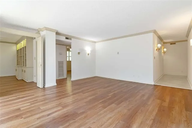 a view of empty room with wooden floor