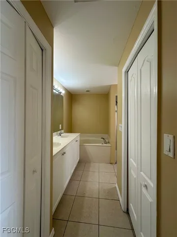 a bathroom with a granite countertop sink a toilet and mirror