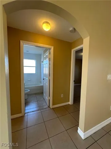 a view of a hallway with wooden cabinets