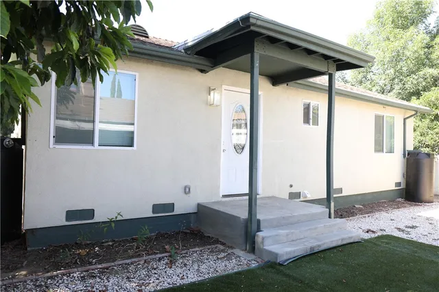a view of a wooden door and a yard