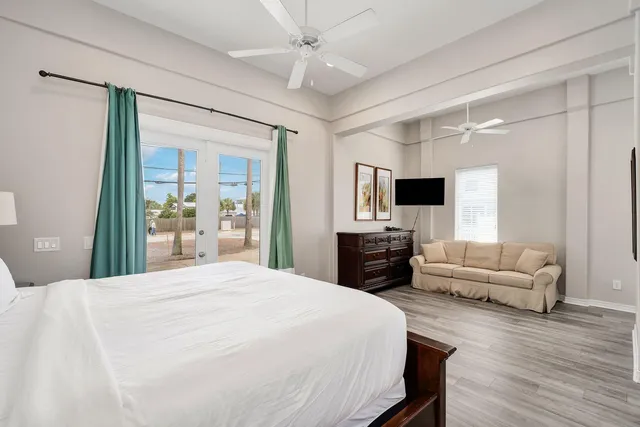 a spacious bedroom with a bed and a flat screen tv