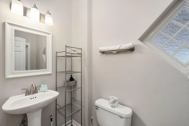 a bathroom with a sink a toilet and mirror