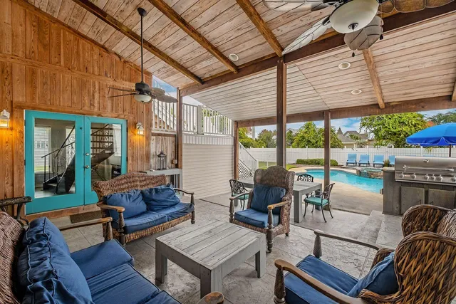 a living room with furniture a flat screen tv and a window
