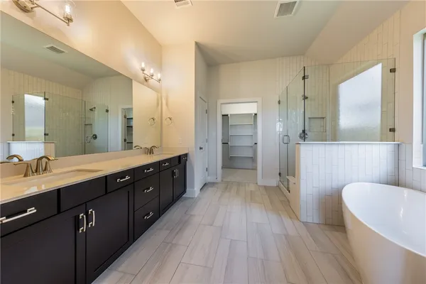 a bathroom with a bathtub and a sink