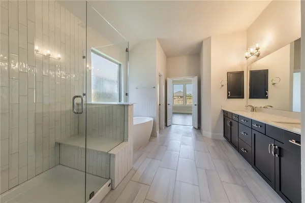 a spacious bathroom with a granite countertop sink mirror and a