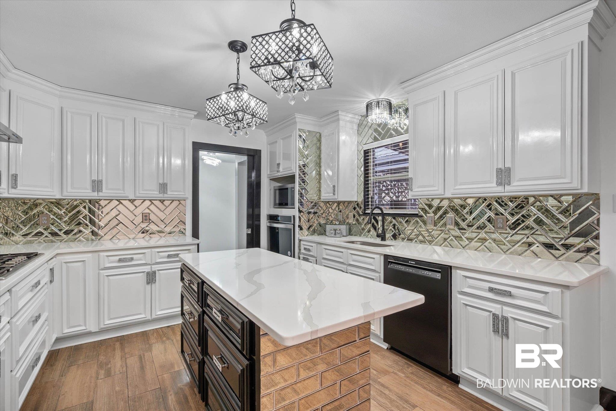 3216 Bay Booster Club Road Theodore, AL 36582 - Photo 7 of 46 Dual tone kitchen featuring light stone countertops, stainless steel appliances, a center island, light wood-style floors, and backsplash