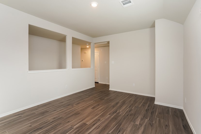 3009 Tallgrass Court Brookshire, TX 77423 - Photo 4 of 17 a view of an empty room with wooden floor and a window