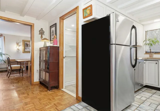 a view of kitchen with furniture and refrigerator