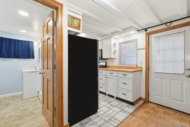 a kitchen with granite countertop cabinets and refrigerator