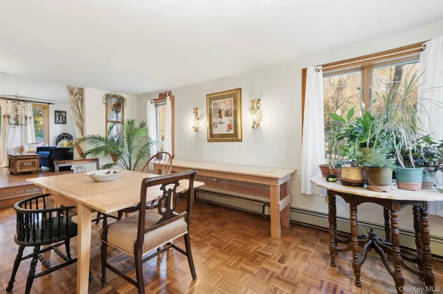 a view of a dining room with furniture window and wooden floor