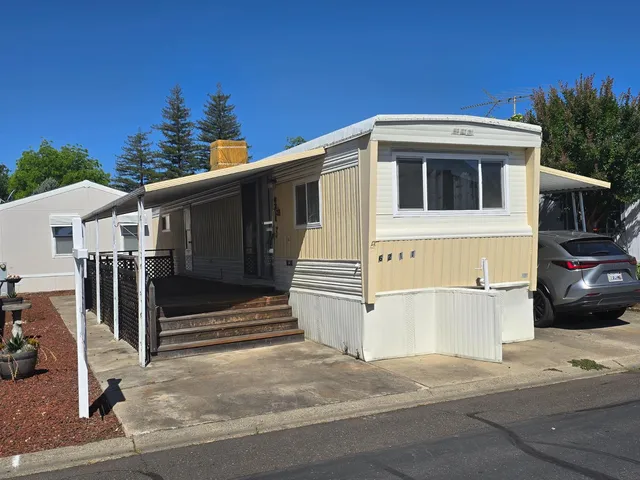 a view of a house with a garage and yard