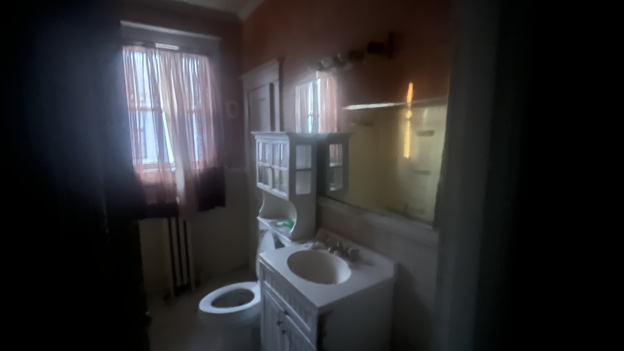 714 Spring Street Memphis, TN 38112 - Photo 16 of 21 a bathroom with a toilet sink and mirror