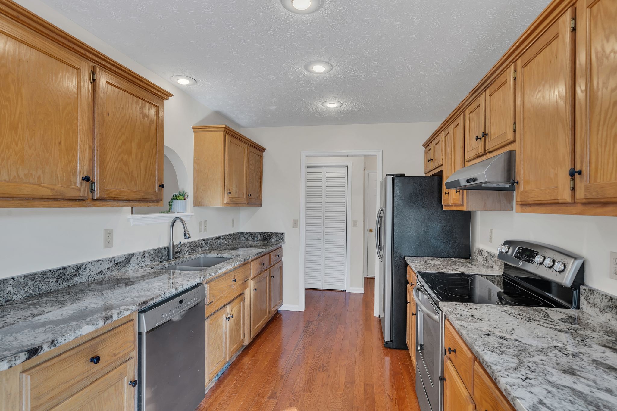 1365 Campbell Ridge Road Kingston Springs, TN 37082 - Photo 11 of 28 a kitchen with stainless steel appliances granite countertop a sink stove and refrigerator