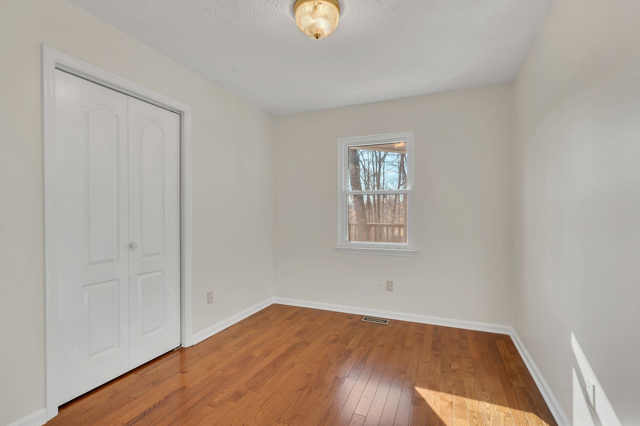 1365 Campbell Ridge Road Kingston Springs, TN 37082 - Photo 12 of 28 an empty room with wooden floor and windows