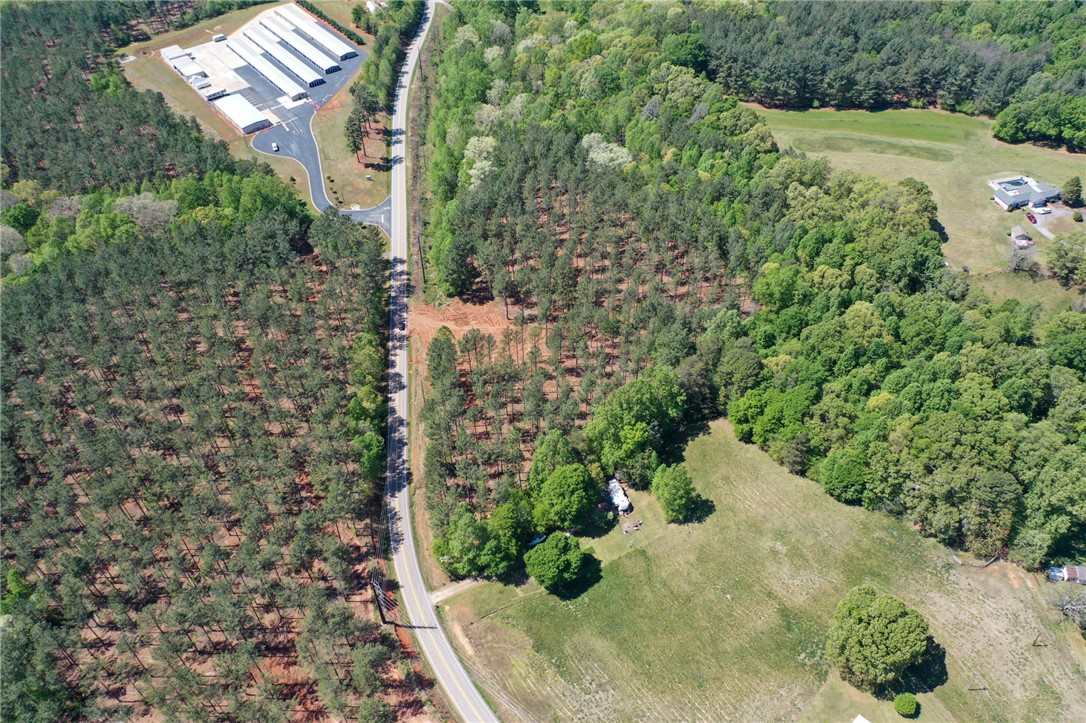 0 Burns Mill Road West Union, SC 29696 - Photo 2 of 10 Expansive acreage provides a verdant canvas for your vision, nestled amidst lush woodland and open fields.