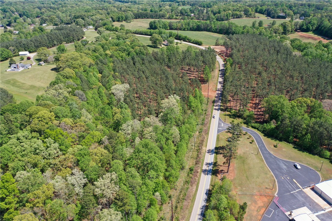 0 Burns Mill Road West Union, SC 29696 - Photo 6 of 10 An aerial view captures the vast expanse of rural landscape, showcasing verdant trees and winding roads.