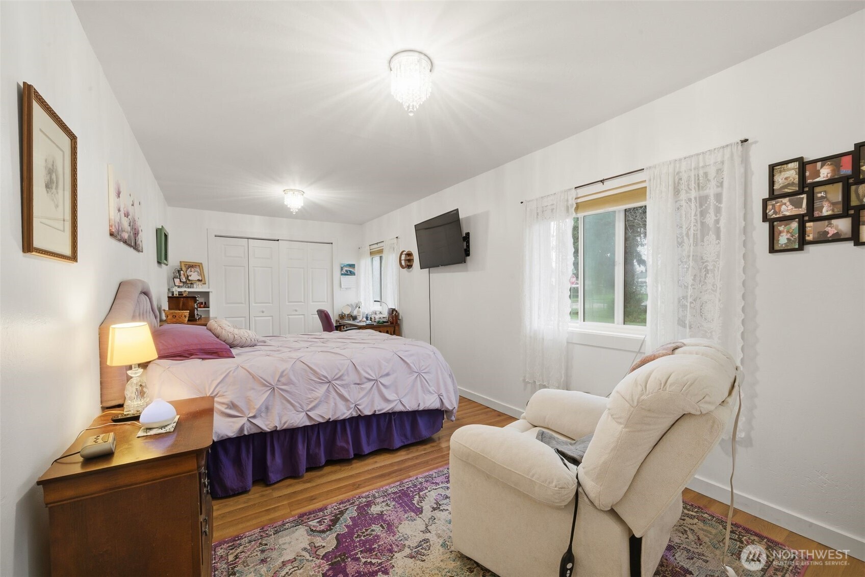701 Jennings Street Sedro-Woolley, WA 98284 - Photo 10 of 40 a bedroom with a bed and wooden floor