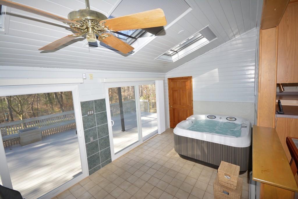 8 Betty Spring Road Freetown, MA 02717 - Photo 18 of 39 a spacious bathroom with a tub sink and glass door