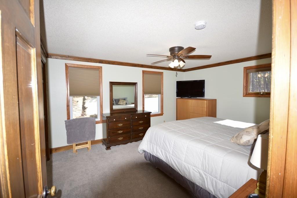 8 Betty Spring Road Freetown, MA 02717 - Photo 24 of 39 a bedroom with a bed and a chandelier