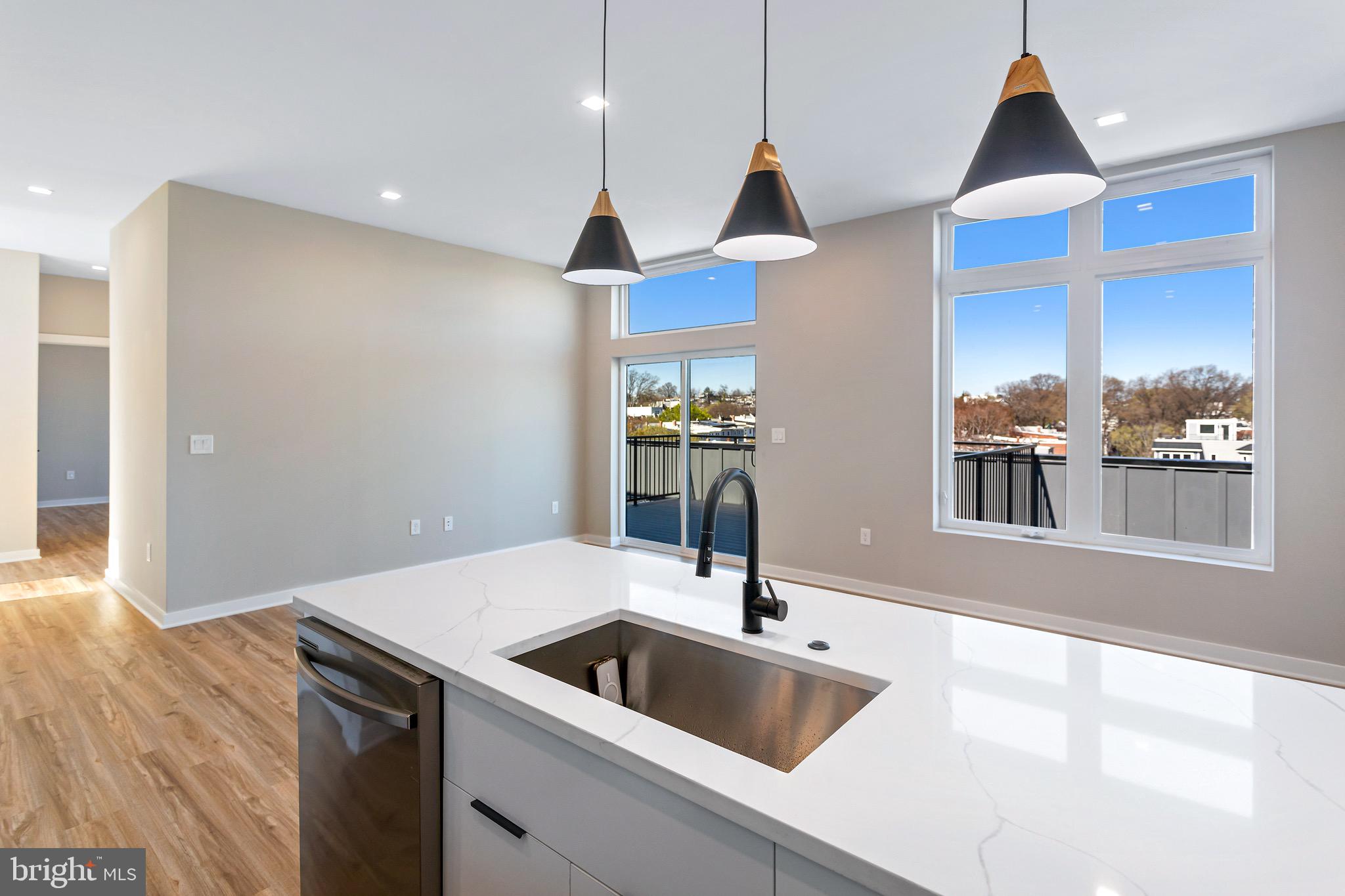 a kitchen with stainless steel appliances granite countertop a sink and a refrigerator