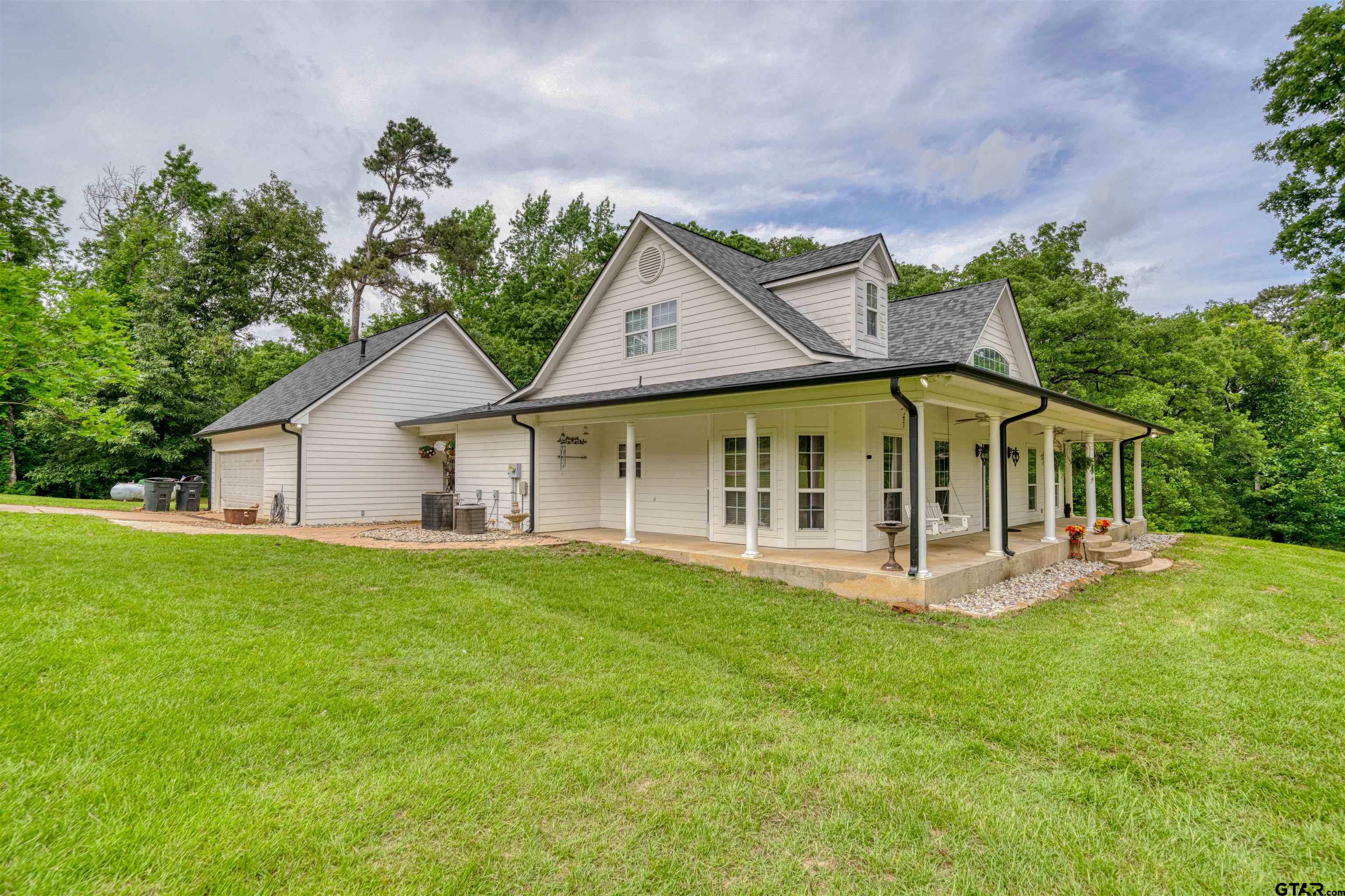 1776 Mustang Road Gilmer, TX 75645 - Photo 5 of 45 a view of a house with a yard and sitting area