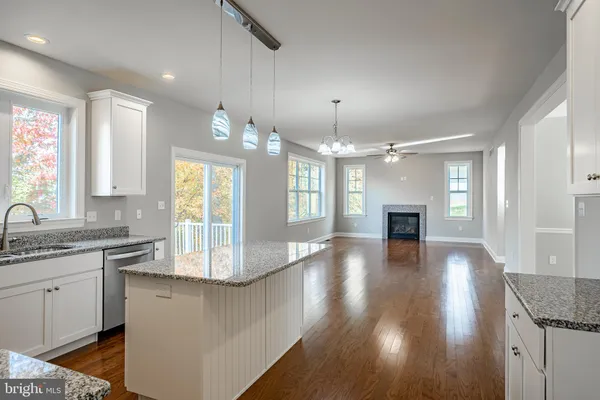 a view of a kitchen and a sink wooden floor