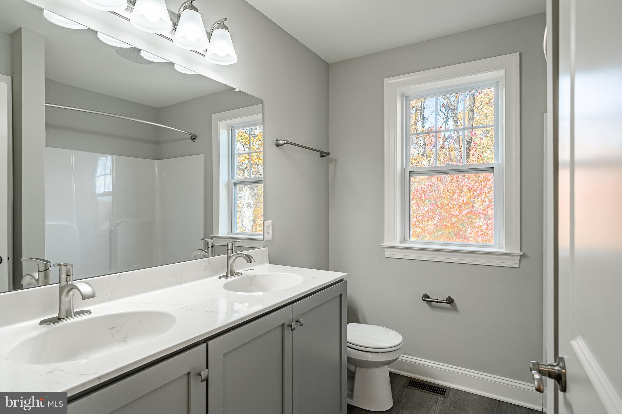 2158 Key Court Kutztown, PA 19530 - Photo 27 of 39 a bathroom with a toilet a sink a mirror a window and vanity