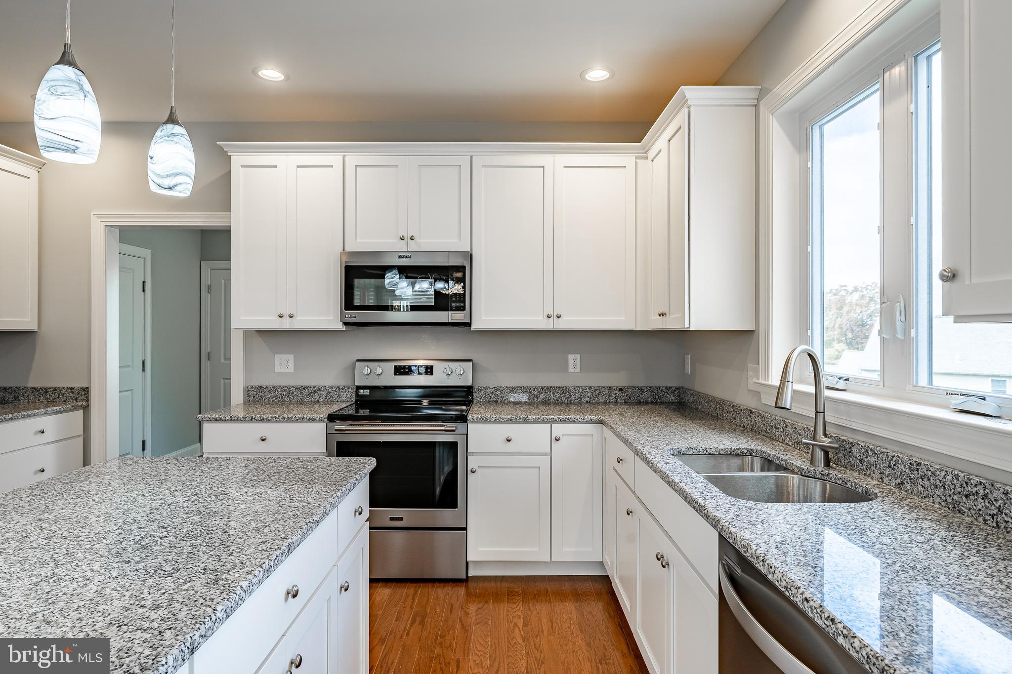 2158 Key Court Kutztown, PA 19530 - Photo 7 of 39 a kitchen with stainless steel appliances granite countertop a sink a stove and a granite counter tops