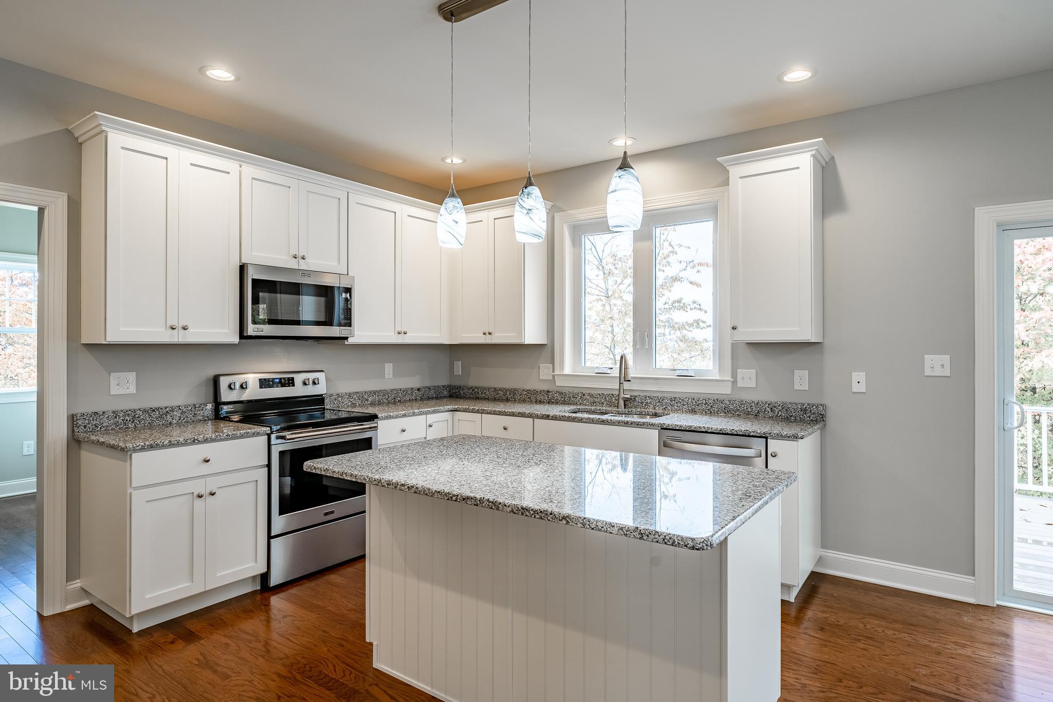 2158 Key Court Kutztown, PA 19530 - Photo 8 of 39 a kitchen with stainless steel appliances granite countertop a sink stove and microwave