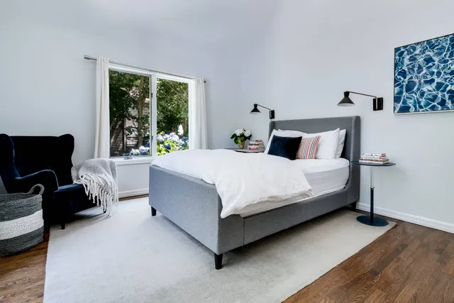 a bedroom with a bed couch and a window