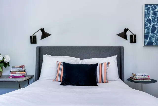 a bedroom with a bed and a night stand