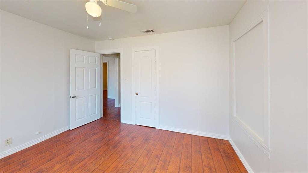 2246 Anson Road Dallas, TX 75235 - Photo 11 of 20 Room featuring wood-finish flooring, white painted walls, a ceiling fan with integrated lighting, and white trim