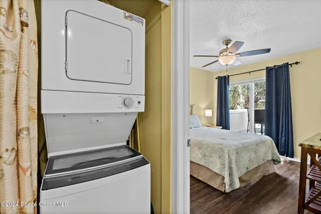 a bedroom with a bed window and a mirror