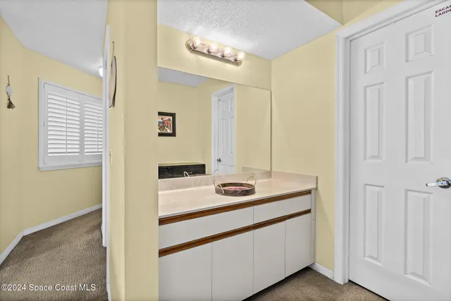 a bathroom with a sink a vanity and a mirror