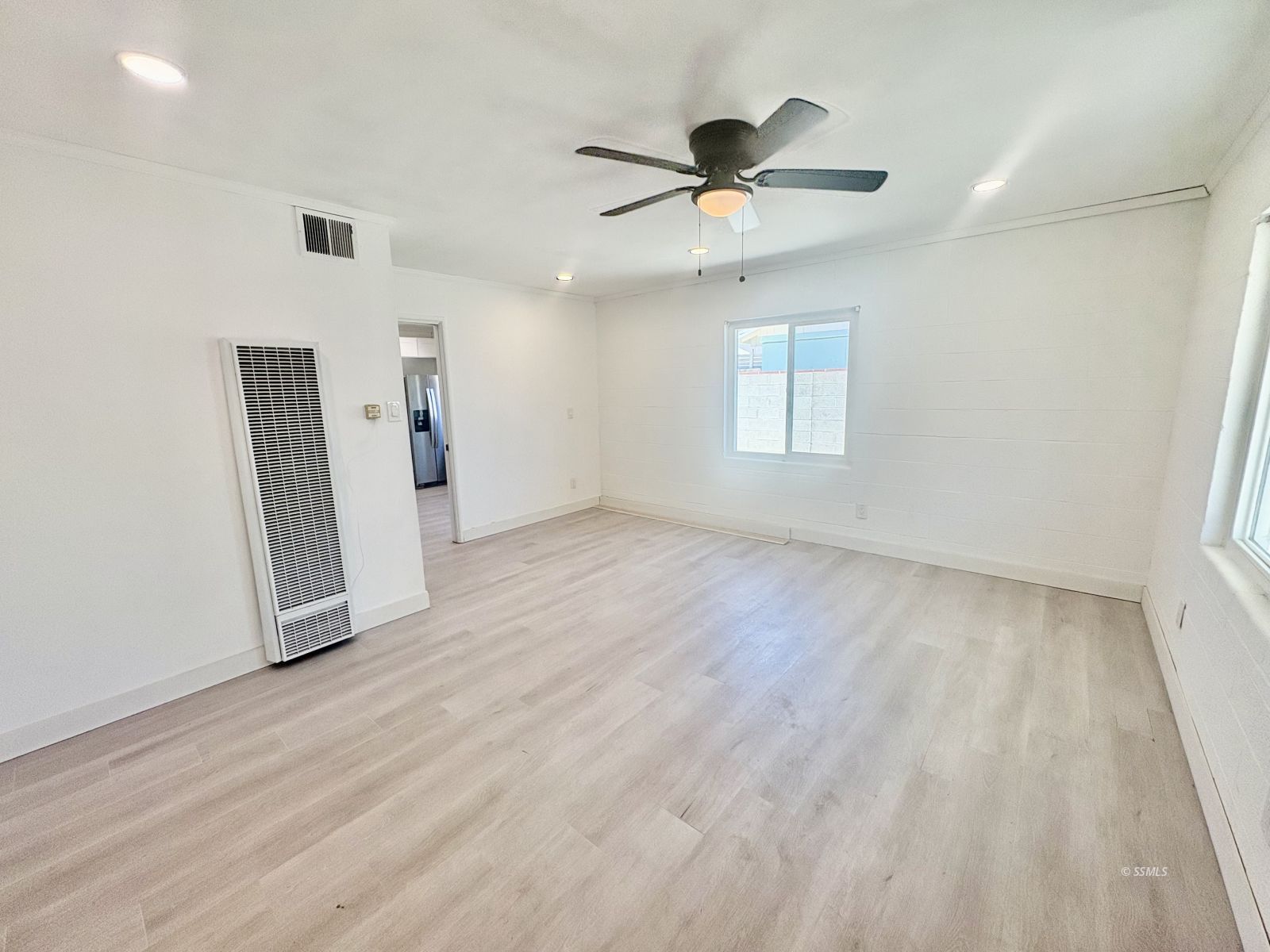 729 North Sanders Street Ridgecrest, CA 93555 - Photo 4 of 17 wooden floor in an empty room with a window