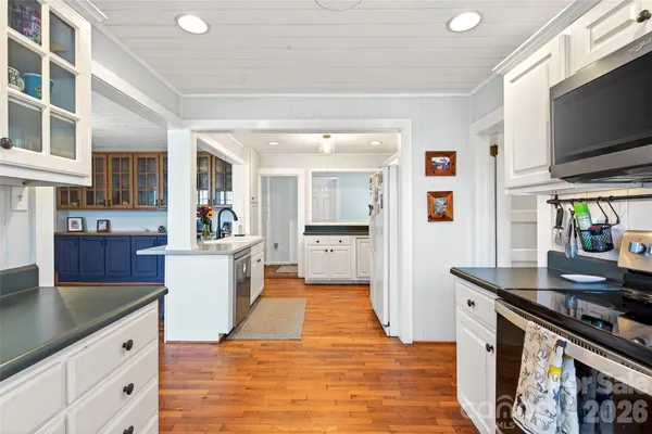 a kitchen with stainless steel appliances granite countertop a sink and a stove