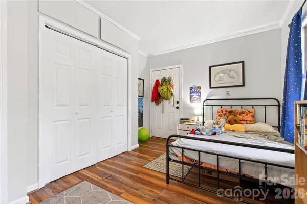 a bedroom with furniture and a wooden floor