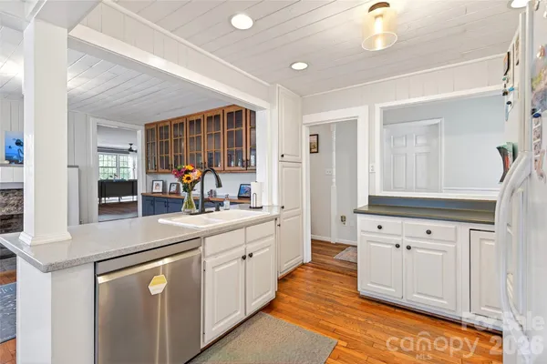 a kitchen with granite countertop a sink and cabinets