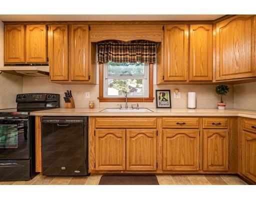 91 Mildred Avenue Springfield, MA 01104 - Photo 15 of 41 a kitchen with stainless steel appliances granite countertop a stove a sink and a microwave
