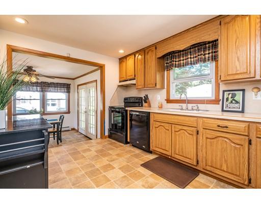91 Mildred Avenue Springfield, MA 01104 - Photo 16 of 41 a kitchen with stainless steel appliances granite countertop a stove a sink and a microwave