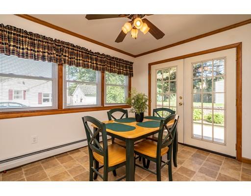 91 Mildred Avenue Springfield, MA 01104 - Photo 17 of 41 a dining room with furniture a chandelier and wooden floor