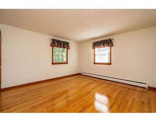 91 Mildred Avenue Springfield, MA 01104 - Photo 28 of 41 a view of an empty room with wooden floor and a window