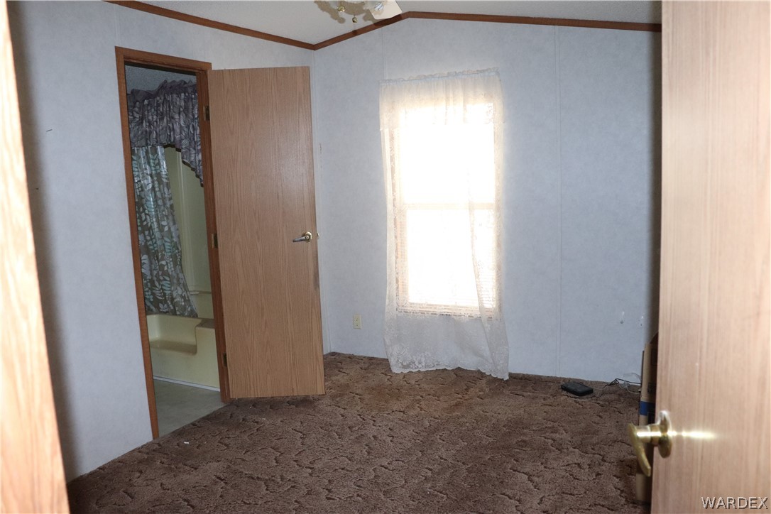 884 Elgin Road Golden Valley, AZ 86413 - Photo 7 of 26 an empty room with windows