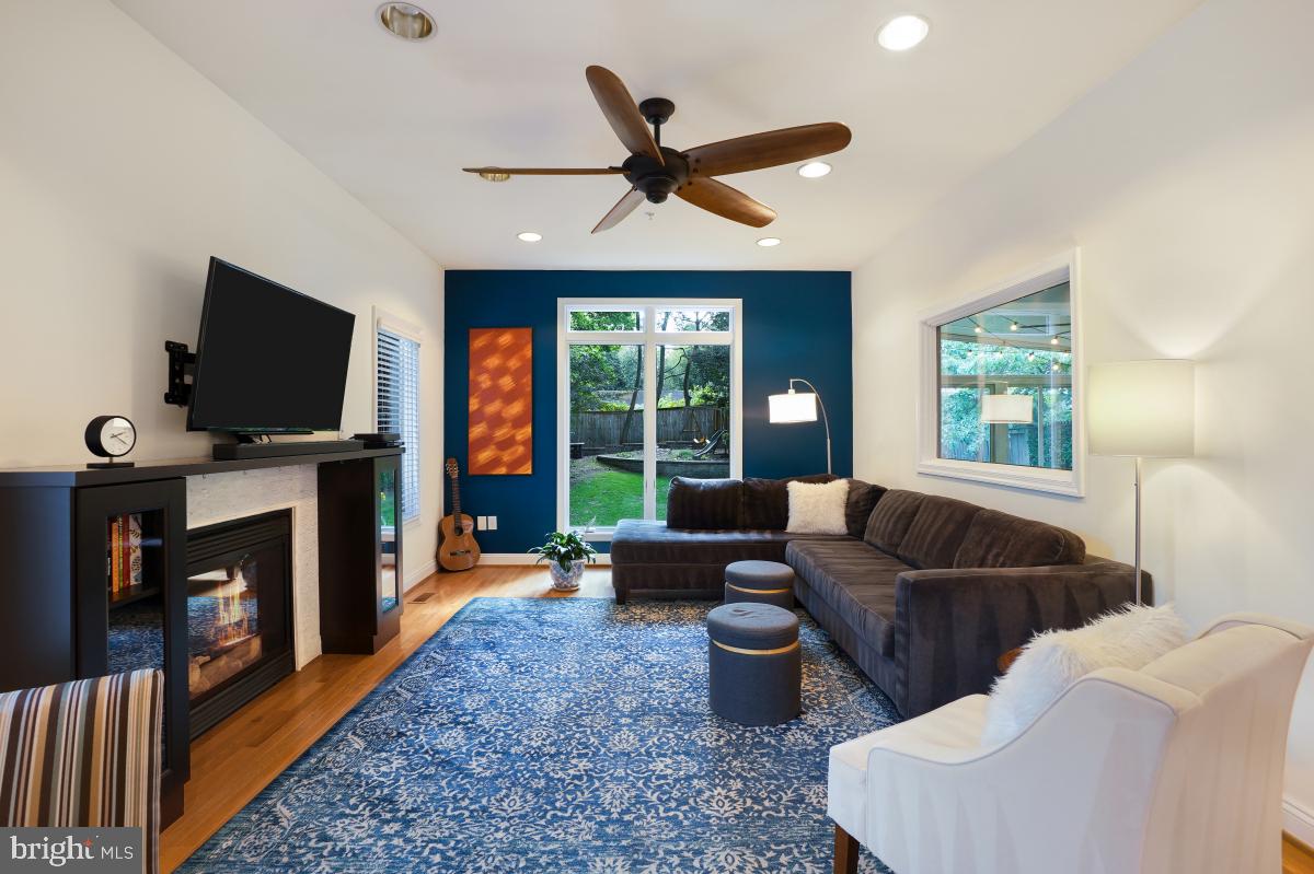 412 Silver Spring Avenue Silver Spring, MD 20910 - Photo 17 of 48 a living room with furniture a fireplace and a flat screen tv