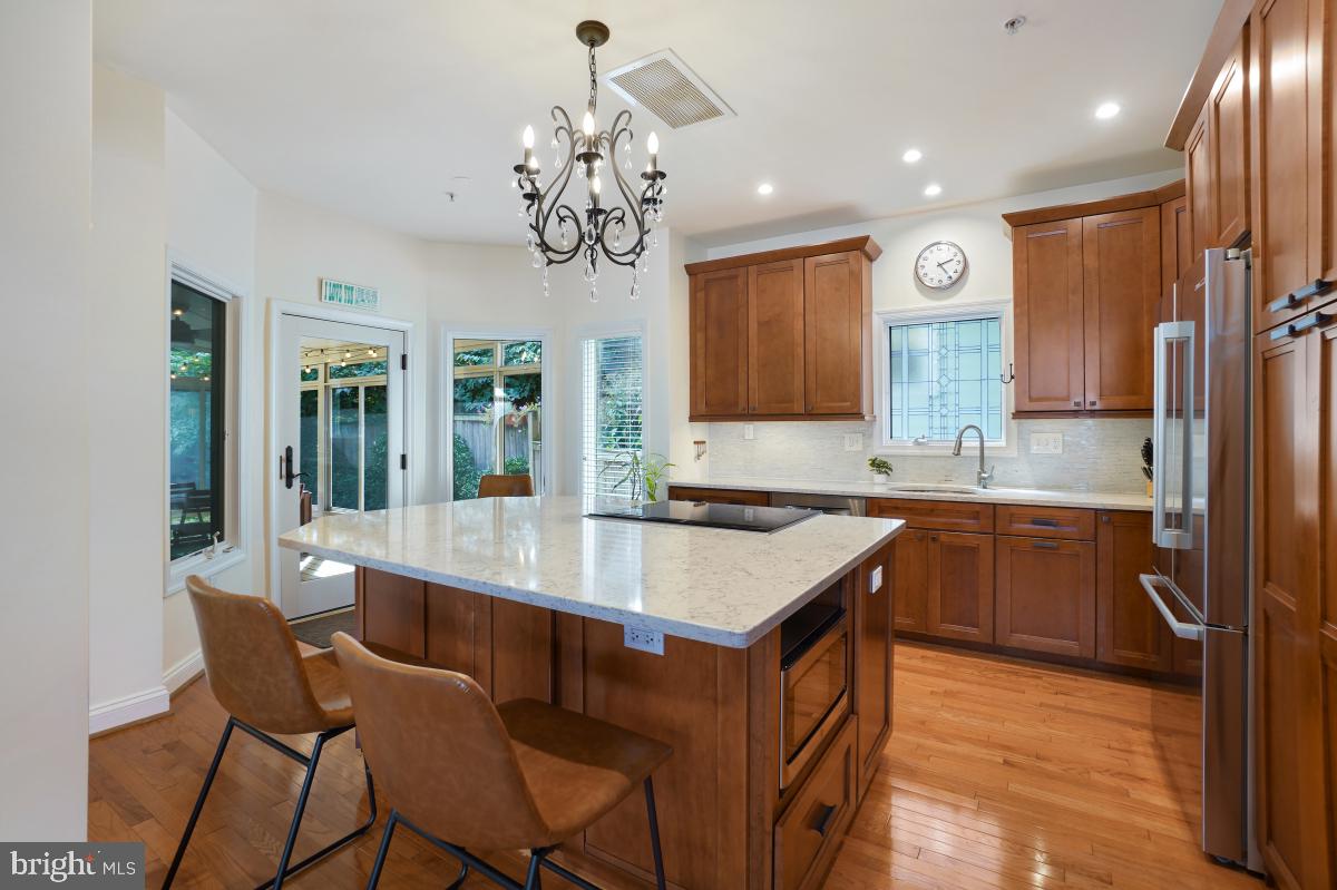 412 Silver Spring Avenue Silver Spring, MD 20910 - Photo 21 of 48 a kitchen with kitchen island granite countertop a sink stove and refrigerator