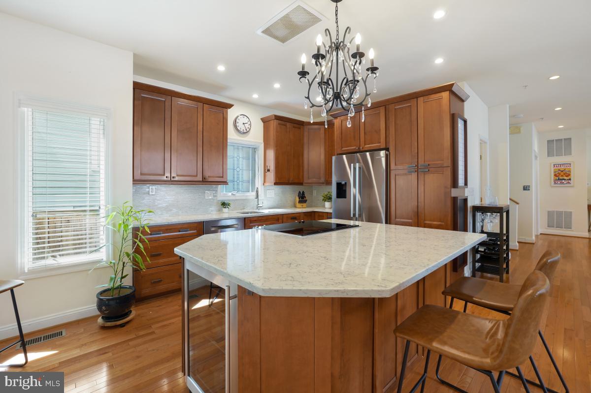 412 Silver Spring Avenue Silver Spring, MD 20910 - Photo 22 of 48 a kitchen with stainless steel appliances granite countertop a kitchen island a stove a table and chairs in it
