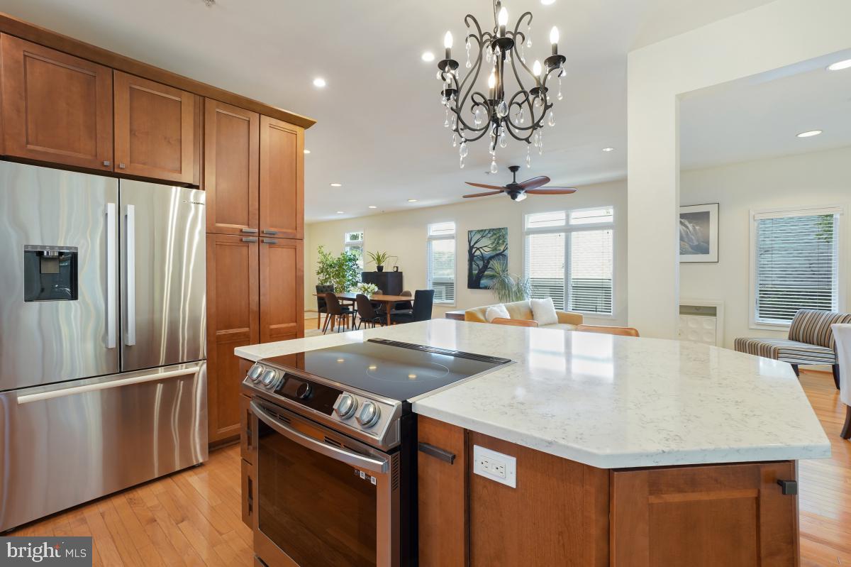 412 Silver Spring Avenue Silver Spring, MD 20910 - Photo 24 of 48 a kitchen with stainless steel appliances granite countertop a sink a refrigerator and a center island