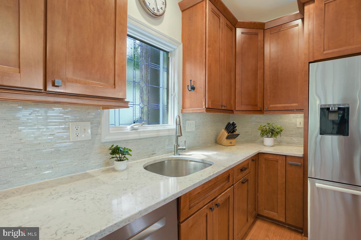 412 Silver Spring Avenue Silver Spring, MD 20910 - Photo 25 of 48 a kitchen with stainless steel appliances granite countertop a sink a refrigerator and a stove