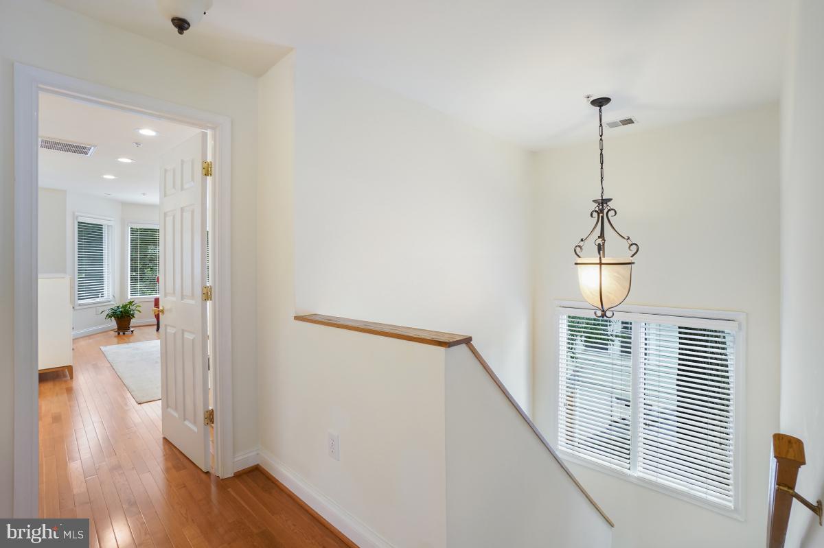 412 Silver Spring Avenue Silver Spring, MD 20910 - Photo 32 of 48 a view of a hallway with wooden floor and staircase